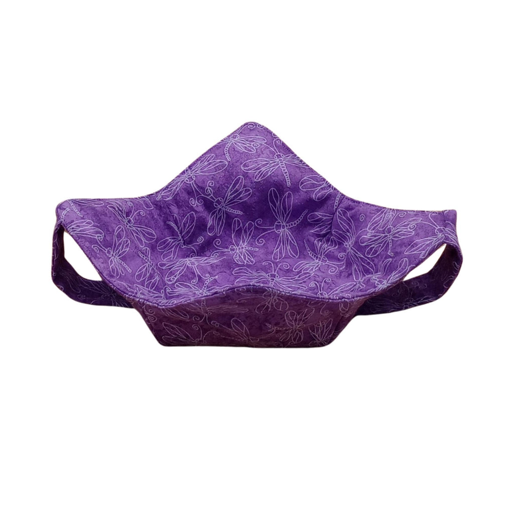 white outlines of dragonflies on a calico purple fabric bowl shaped holder with a matching fabric strap underneath the holder