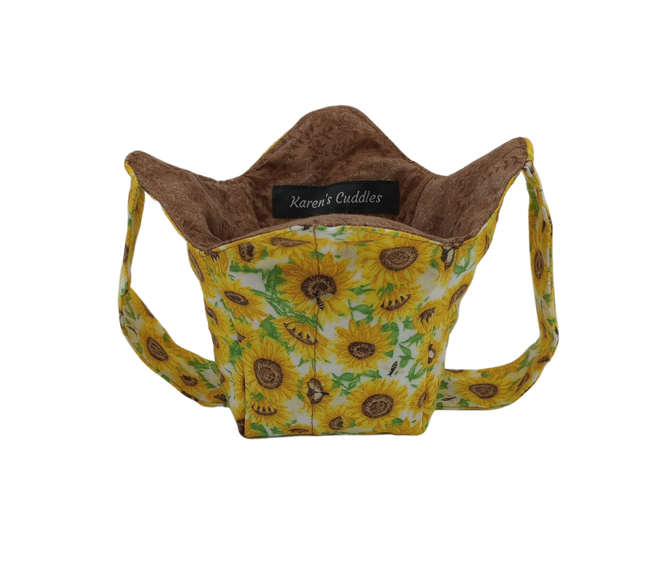 yellow and brown sunflowers with green leaves on white fabric, reversible to a brown fabric with brown leaves. This cozy is shaped to hold pint size ice cream containers and 14 ounce mason jars, features a strap for hand support.