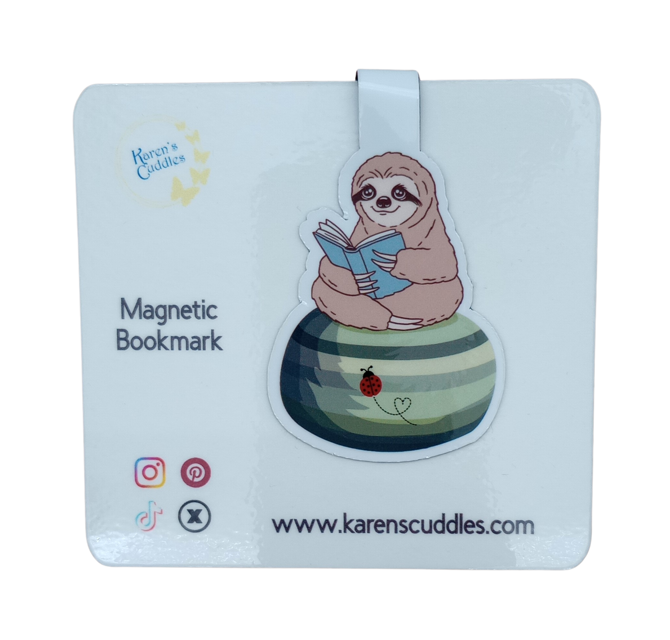 Magnetic bookmark with a sloth reading a book sitting on a green beanbag with a ladybug on it