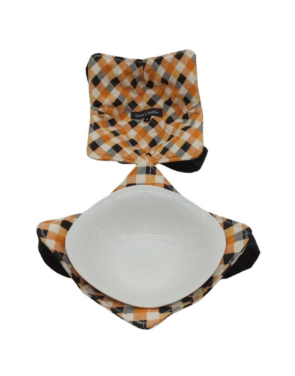 This bowl cozy is reversible, features white cotton fabric with orange and black squares, same print on both sides.  Bowl cozies are hot pads designed to hold hot or cold bowls, has a black versatile strap for hand support and easy storage. Cozies can be used in the microwave to reheat food as well as double for a placemat. This cozy offers two sizes holding a small soup bowl up to 6.5&quot; diameter or a medium pasta bowl up to 7.5” diameter.