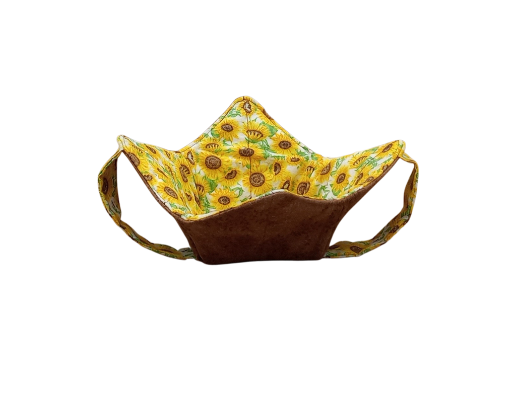 brown leave fabric with sunflower strap on outside, sunflowers on inside bowl shaped holder