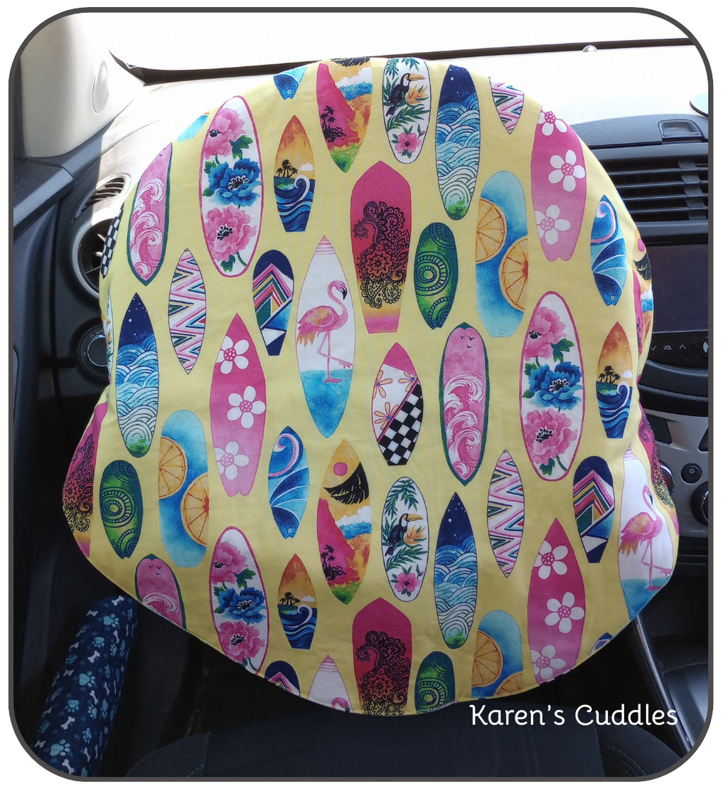 surfboards of different designs on yellow cotton fabric steering wheel cover